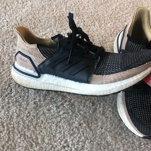 Black and gold/tan men’s adidas ultraboosts